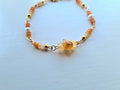 Handmade citrine bracelet held in hand