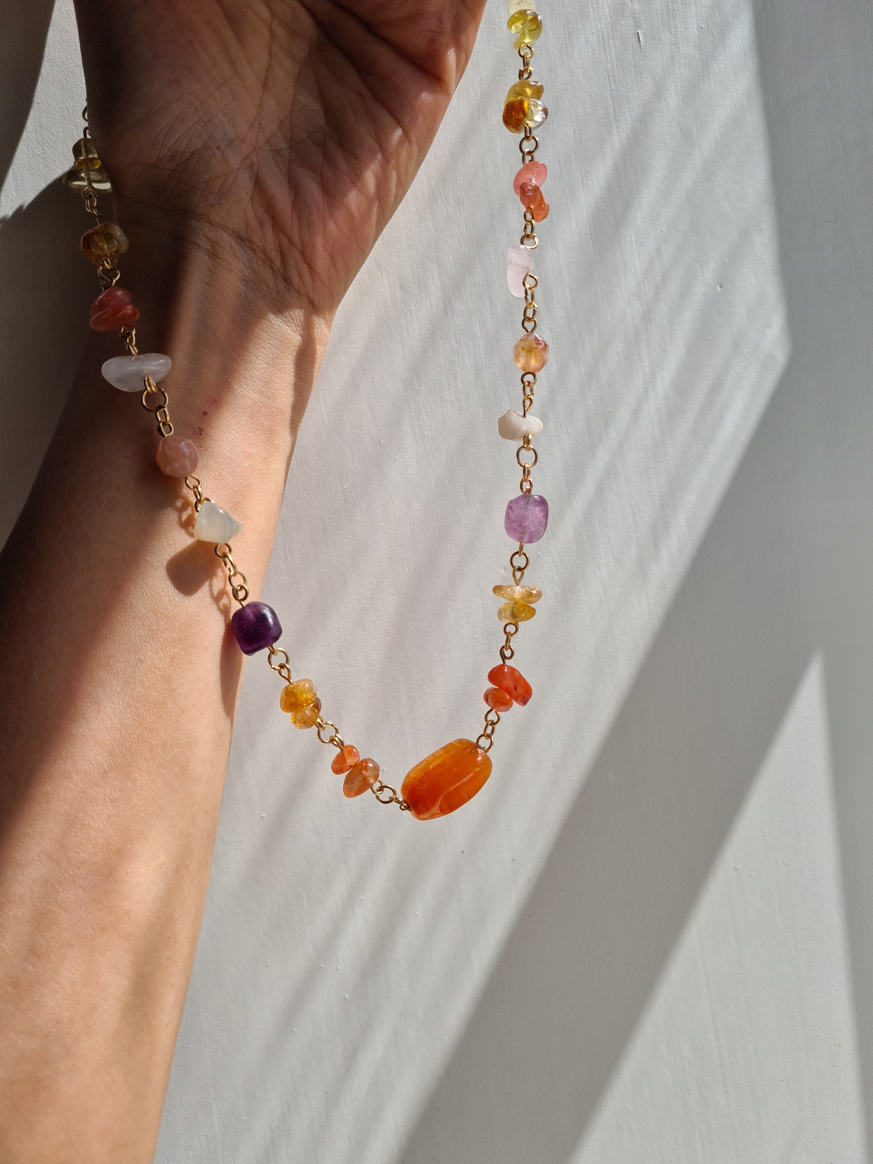 Mixed gemstone necklace close-up in sunlight